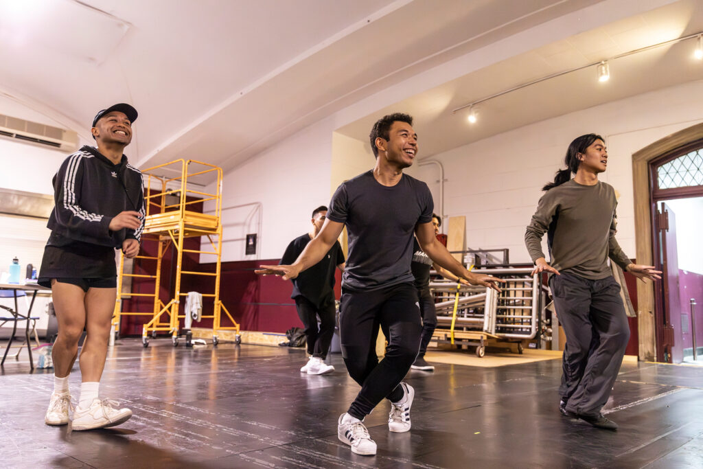 a group of dancer rehearsing and laughing together