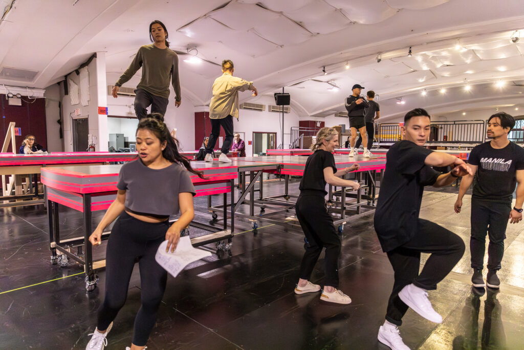 dancers moving around and on top of tables