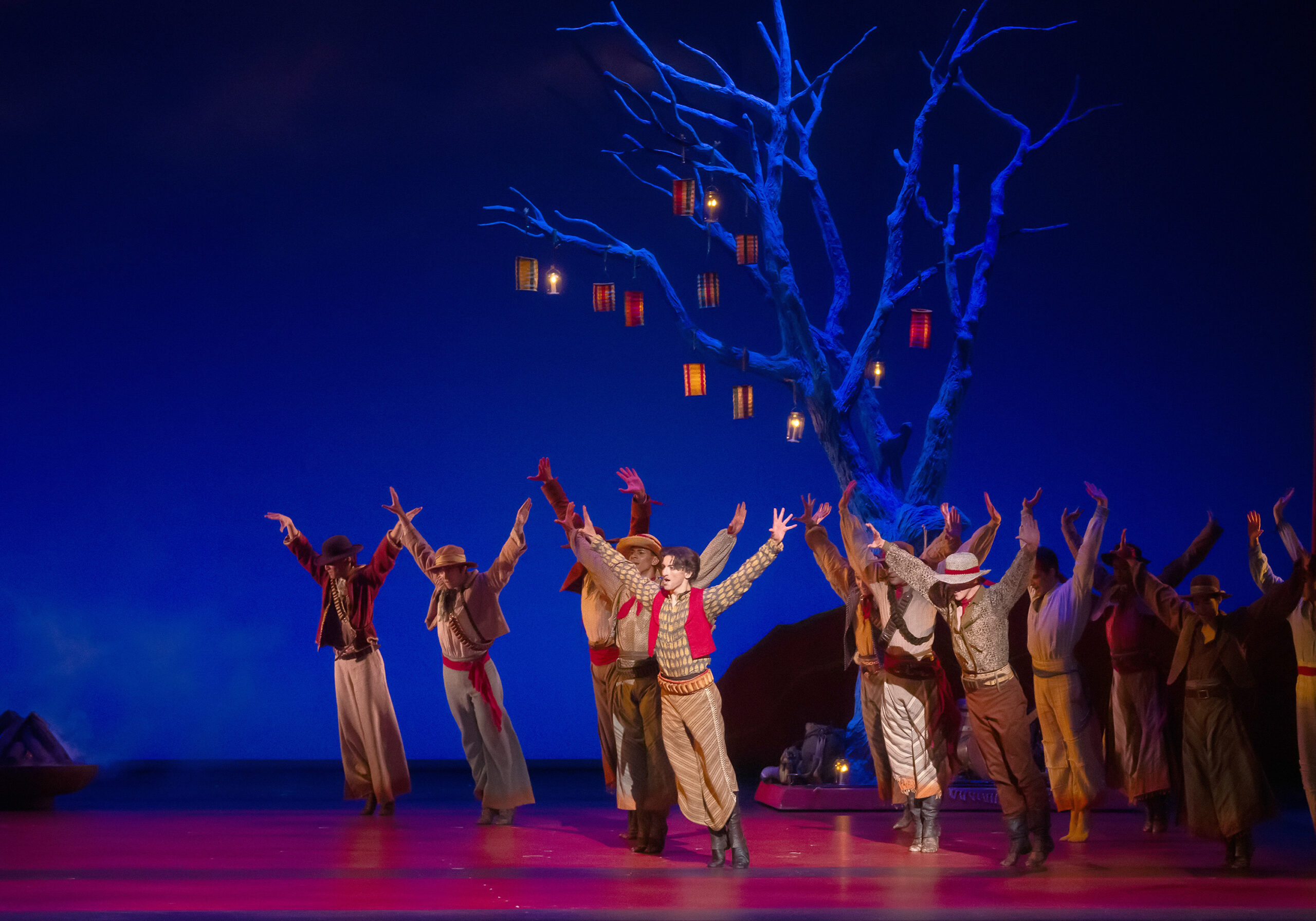 a group of male dancers in releve holding their arms out to the side with hands flexed