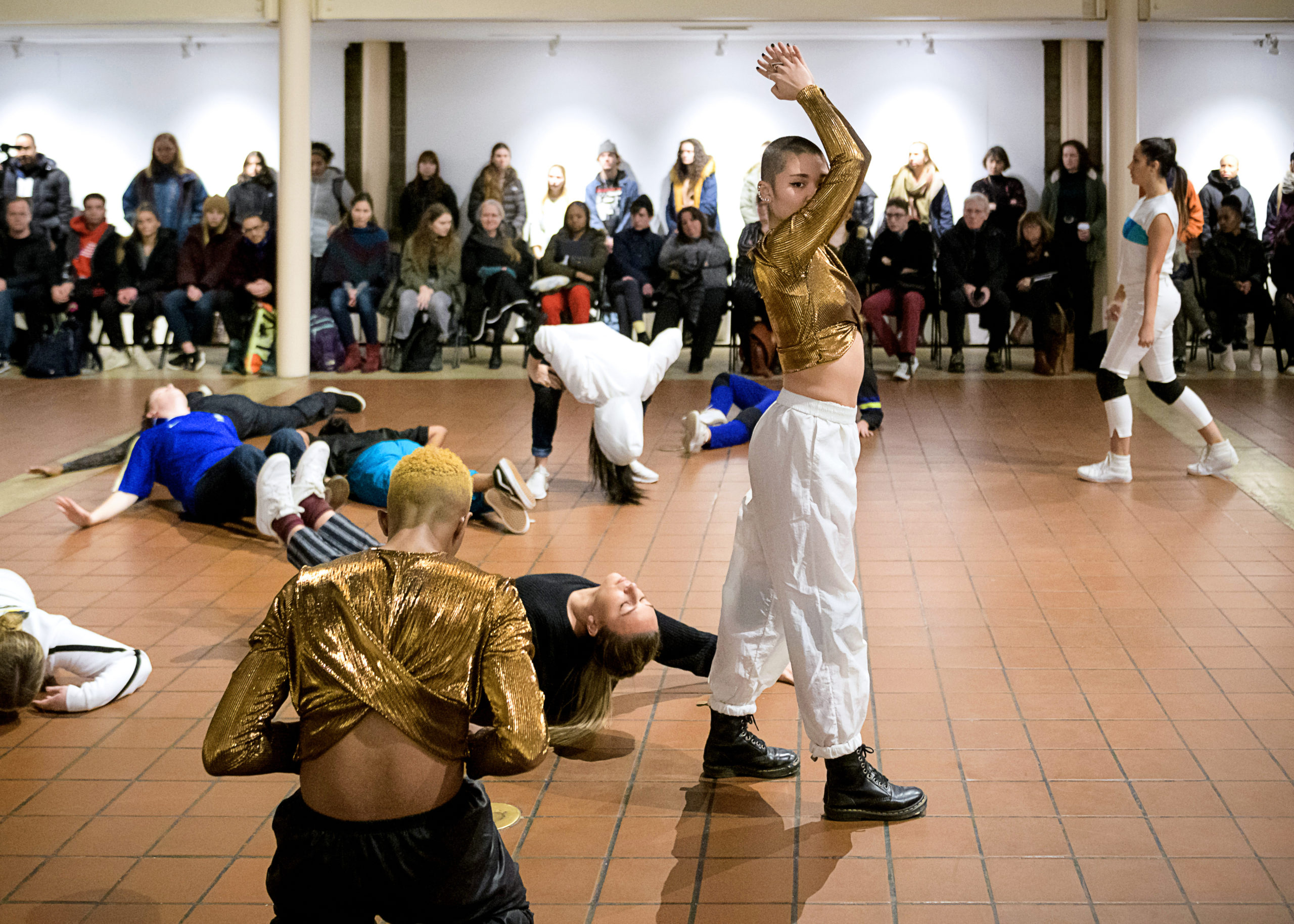 a group of dancers performing in large room