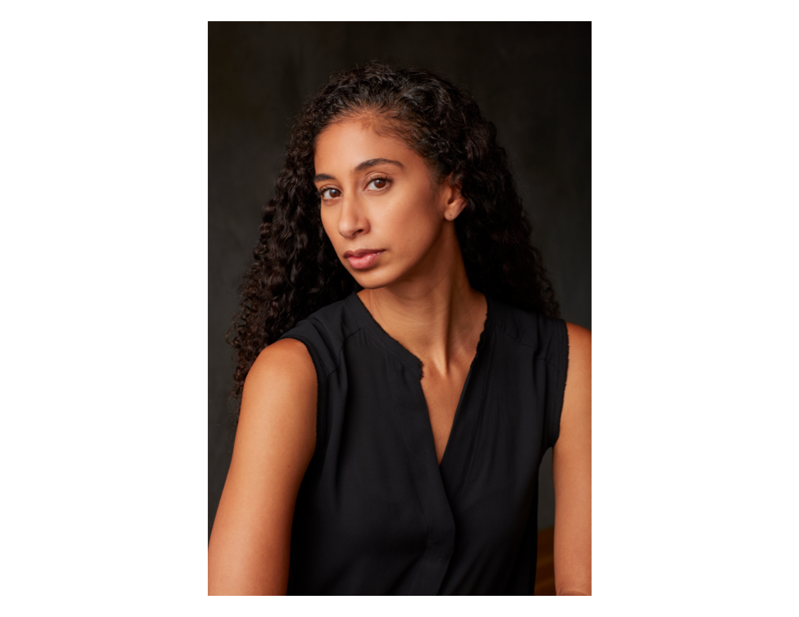 a woman wearing black looking at the camera